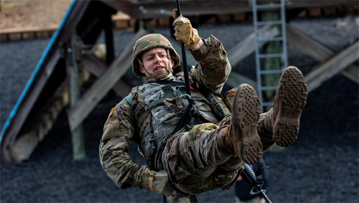 Military personnel rapelling