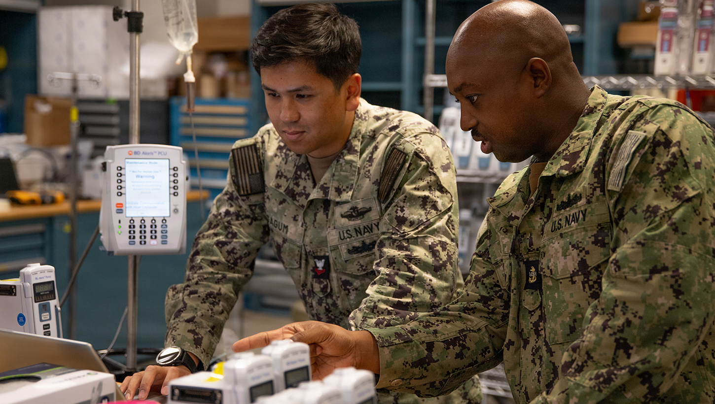 U.S. Navy Hospital Corpsman Chief Petty Officer Antares Zongo, material management equipment division leading chief petty officer at Naval Medical Center San Diego, provides instruction to Hospital Corpsman 2nd Class Arielle Sagum, biomedical equipment technician