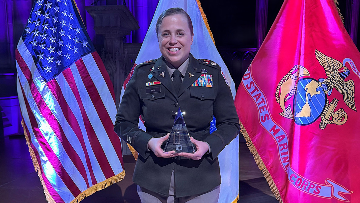 Maj. Erika B. Page holding her 2026 Hero of Military Medicine Award