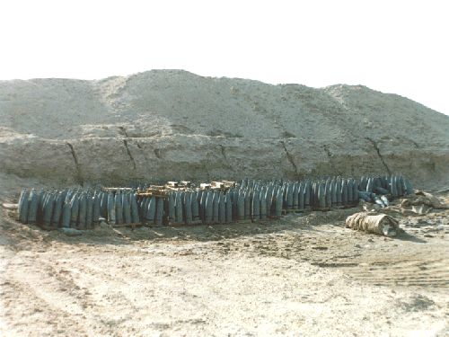 Figure 12.  UNSCOM photograph of Iraqi 155mm mustard rounds at Khamisiyah