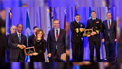 Dr. Jouhayna Bajjani-Gebara (left) and Navy Cmdr. Dr. James Hawkins (right) accept their respective 2026 AMSUS Nursing and Dental awards during the society's annual meeting