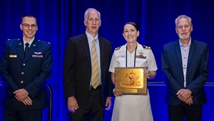 U.S. Navy Lt. Com. Kezia Edmonson receives her Young Investigator award at the 2024 Military Health System Research Symposium.