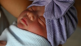 Link to Photo: Emergency and labor teams work together to care for mother, baby delivered in car