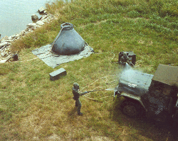 Figure 19. Soldiers in training use a Sanator TM to decontaminate a vehicle.
