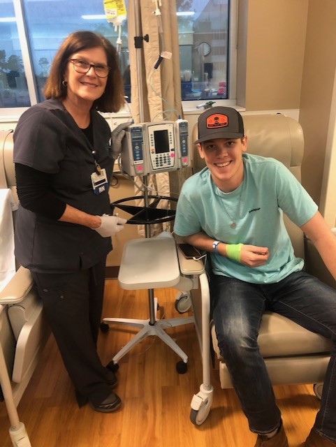Photo of Dalton Mask with a nurse during a chemo treatment.