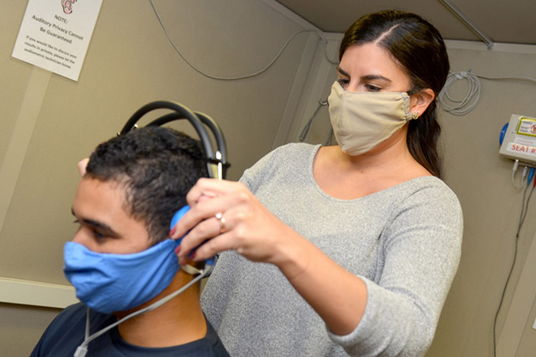 Kori Reese, an audiology technician at Naval Branch Health Clinic Jacksonville’s occupational health clinic, conducts a hearing exam with Airman Diosney Moraga. Naval Hospital Jacksonville and Navy Medical Readiness and Training Command Jacksonville won the Chief of Naval Operation’s Award for Achievement in Ashore Safety (large non-industrial command) for Fiscal Year 2019. (U.S. Navy photo by Jacob Sippel).