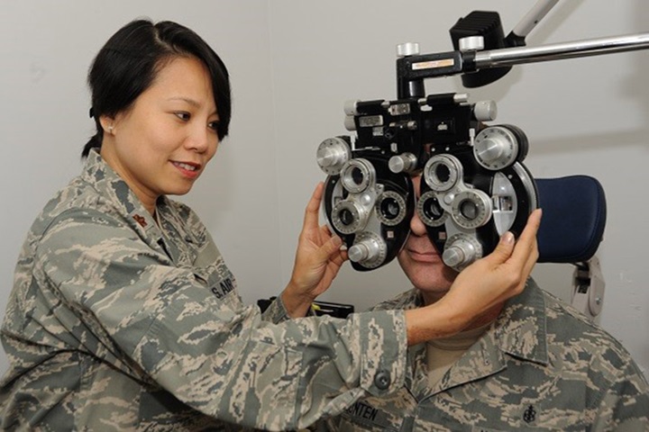Image of Ophthamologist Air Force Maj. Thuy Tran evaluates a patient during an eye exam. (U.S. Air Force photo by Tech. Sgt. John Hughel).