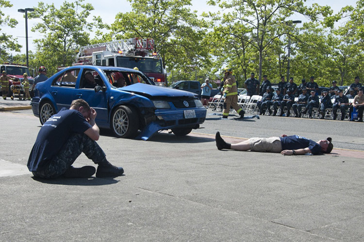 Sailors simulate a drunk driving accident during a Keep What You've Earned fair on Naval Base Kitsap Bangor. The fair encourages responsible alcohol use by celebrating the achievements in the sailors' Navy careers and actively engages sailors as advocates for responsible drinking. (U.S. Navy photo by Mass Communication Specialist 3rd Class Chris Brown)