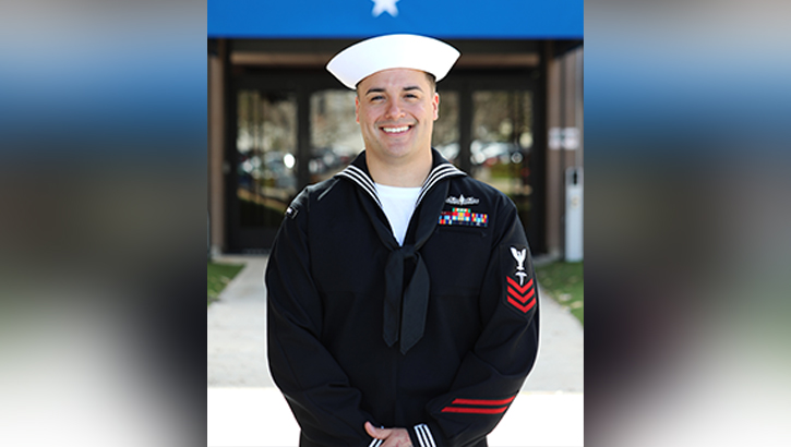 U.S. Navy Hospital Corpsman 1st Class Peter Munoz poses in front of the Naval Medical Forces Pacific headquarters 