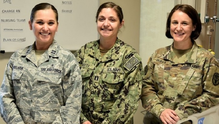 Image of Three women in military uniforms standing together.