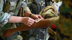 U.S. Air Force Airmen assigned to the 18th Medical Group and service members assigned to the U.S. Navy Ground Surgical Team treat a simulated patient during an USAF-led operational readiness exercise