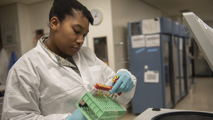 U.S. Air Force Staff Sgt. Ashley Solomon, 18th Medical Support Squadron NCO in charge of microbiology, unloads blood samples from a centrifuge at Kadena Air Base, Japan, Jan. 31, 2019. (Photo: Tech. Sgt. Matthew B. Fredericks, U.S. Air Force)