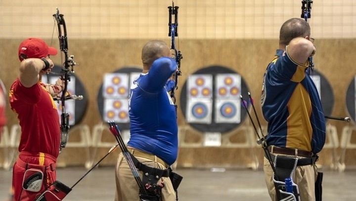 Image of Three men shooting arrows at targets.