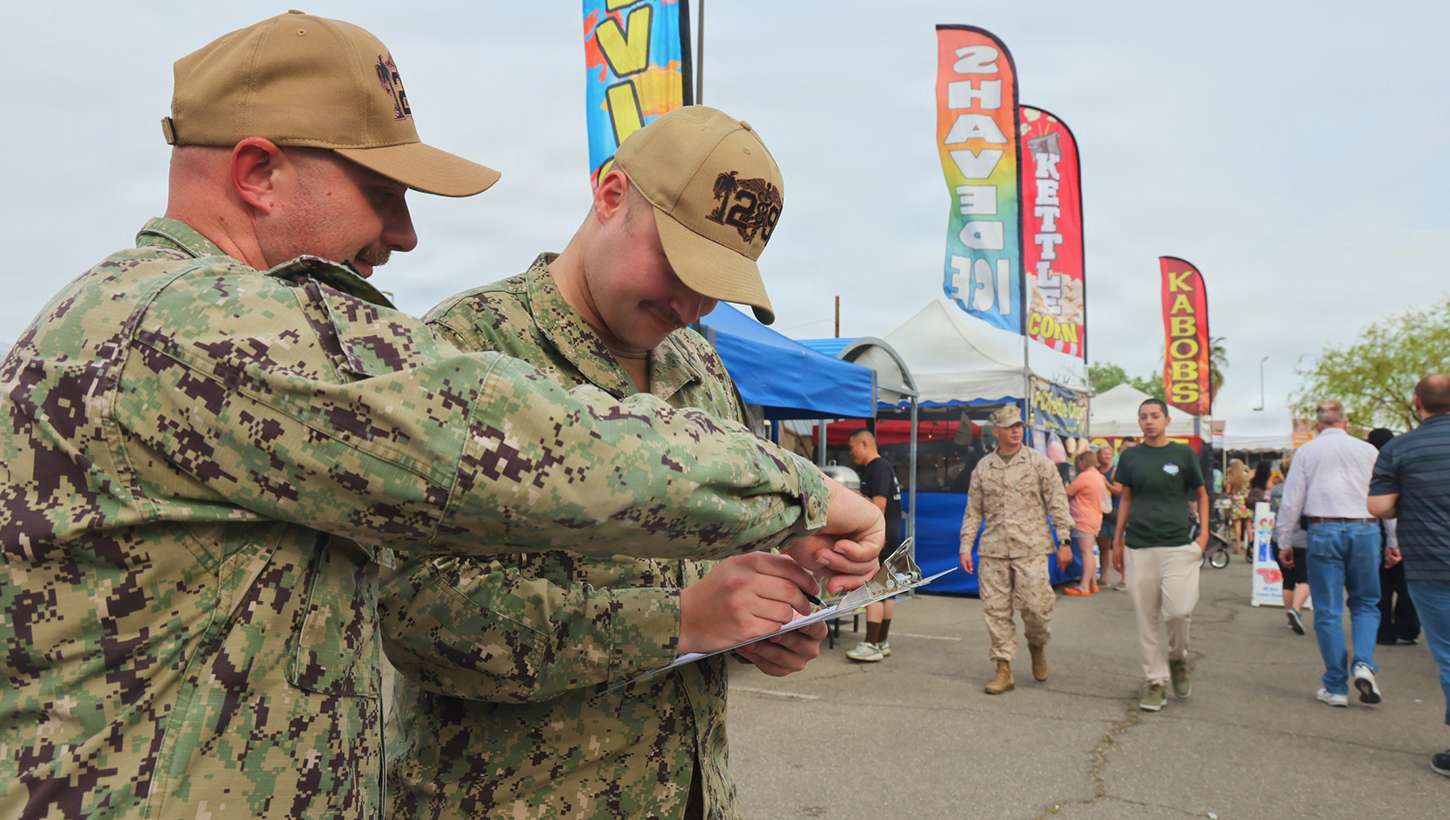 Hospital Corpsman 1st Class Sean Wiemer (left) and Hospitalman Apprentice Wilson Current (right) conduct food safety inspections