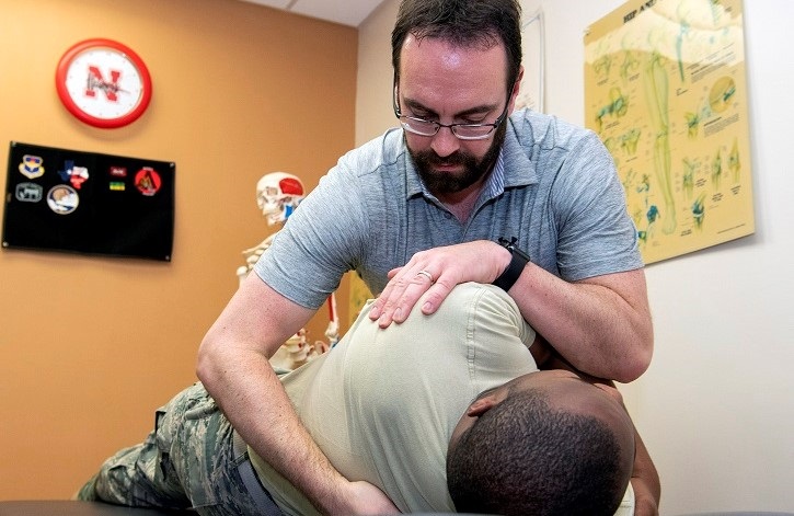 Chiropractor adjusting another man's back