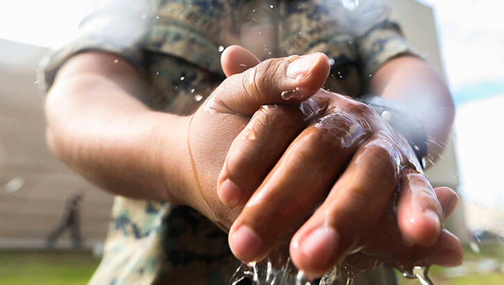 Image of Marines with Marine Wing Headquarters Squadron, 3rd Marine Aircraft Wing take precautionary measures by cleaning and disinfecting their hands during field day on Marine Corps Air Station Miramar, Calif., March 20, 2020, to mitigate the spread of COVID-19 while continuing to perform mission-essential tasks. (Photo: Marine Corps Lance Cpl. Jaime Reyes). Click to open a larger version of the image.