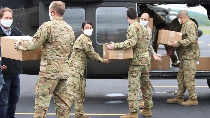 Soldiers loading boxes onto helicopter