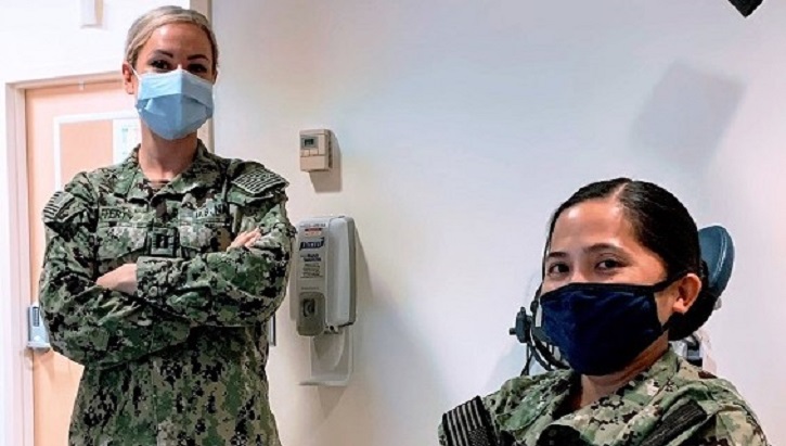 Image of two military personnel wearing masks. Click to open a larger version of the image.