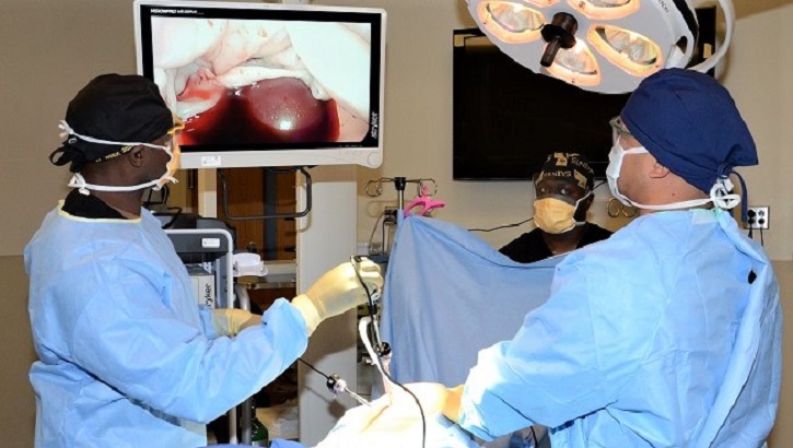 Image of Surgical team in operating room. Click to open a larger version of the image.