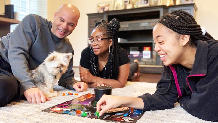 Image of Family playing board game. Click to open a larger version of the image.