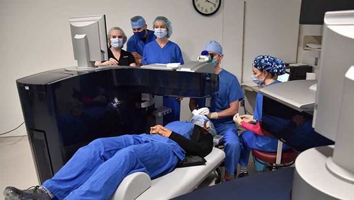 Image of A surgical team with the Warfighter Refractive Eye Surgery Program at Womack Army Medical Center at Fort Bragg monitors the progress of a patient's surgery inside the Ophthalmology Clinic's Refractive Surgery suite.