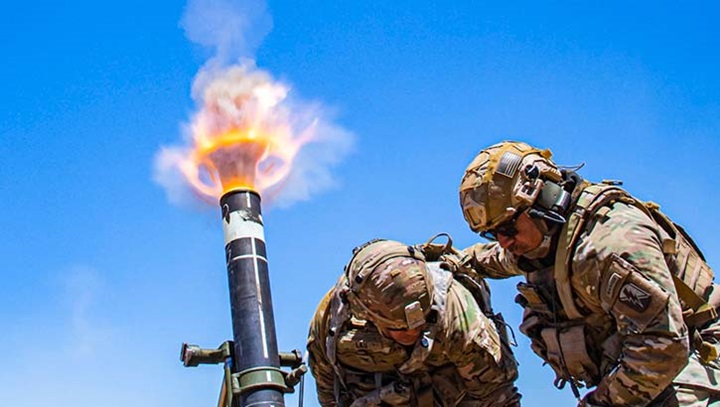 Image of Army Col. Randy Lau fires a 120 mm mortar during a live-fire exercise at Camp Roberts, California, June 15, 2021.