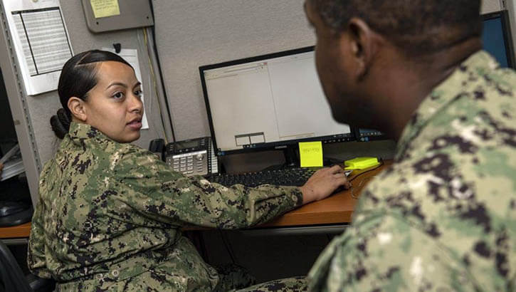 Military personnel viewing laptop