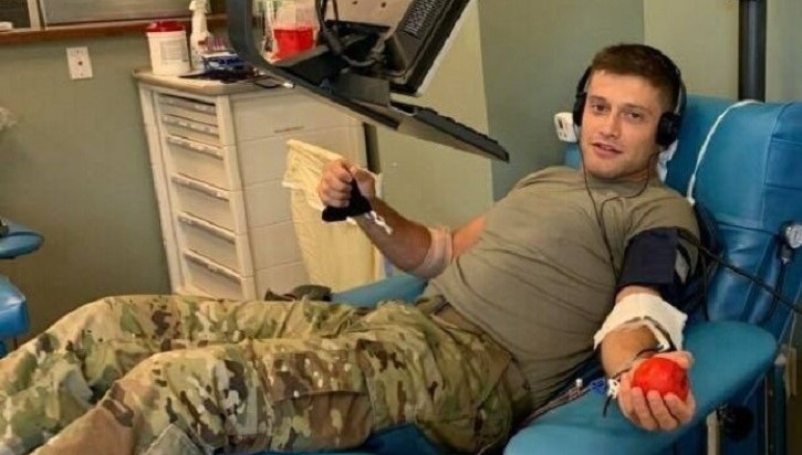 Soldier in chair, giving blood