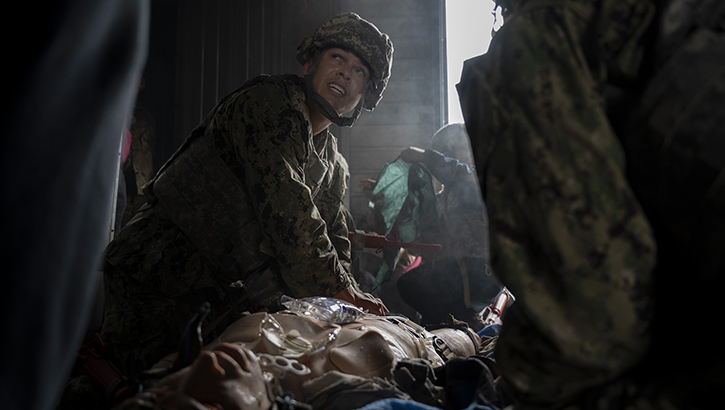 U.S. Navy Hospital Corpsman 2nd Class Maliq Webster, assigned to the Whidbey Island-class dock landing ship USS Rushmore, performs critical medical care on a simulated patient during a tactical combat casualty care training exercise at Yokota Air Base, Japan, on April 3, 2025. Facilities on Yokota can recreate maritime-specific environments through training elements like smoke effects and low-light conditions, which provide sailors with realistic, shipboard-relevant training. (Photo by U.S. Air Force Senior Airman Samantha White)
