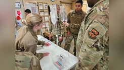 Medics from the 49th Medical Group troubleshoot a beeping IV during MEDIC-X training at Holloman Air Force Base, New Mexico, Jan. 15, 2025.