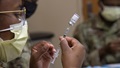 An Airman from the 6th Medical Group prepares a COVID-19 vaccine for distribution at MacDill Air Force Base, Florida.