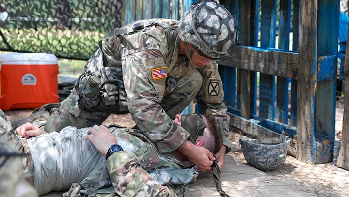 Image of Pvt. Second Class Jagger Dixon, treats an eye injury during Expert Infantryman Badge testing, June 15, 2021, at Fort Polk, Louisiana. Dixon is a soldier with B Company; 2nd Battalion, 4th Infantry Regiment, 3rd Brigade Combat Team, 10th Mountain Division. Soldiers must successfully execute a variety of warrior tasks to earn their EIB. (Photo: Army Spc. Kay Edwards, 27th Public Affairs Detachment).