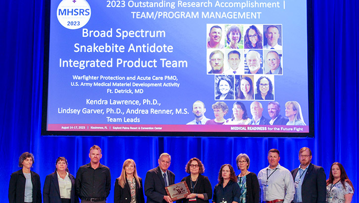Team members from the U.S. Army Medical Research and Development Command's Medical Material Development Activity - Broad Spectrum Snakebite Antidote (BSSA) program, receive the Military Health System Research Symposium 2023 Outstanding Research Accomplishment award in team/program management in Kissimmee, Florida on August 14, 2023.  (Photo: Danae Johnson)