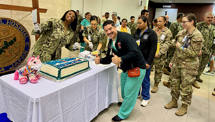 Sailors from USNMRTC Okinawa enjoys cake the morning of the MHS GENESIS launch. (Photo: Isaac Savitz)