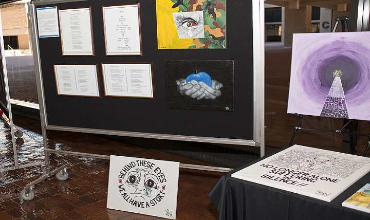 The "Behind these eyes, we all have a story" painting on display at the 2015 Warrior Care in the 21st Century symposium demonstrates that art therapy is an effective outlet for service members to express emotions inflicted by their invisible wounds