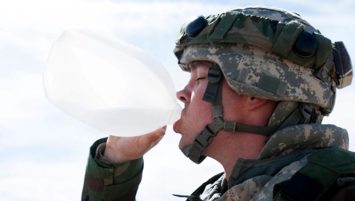 Image of A soldier assigned to the 256th Combat Support Hospital, Twinsburg, Ohio, drinks water from a gallon-sized jug during Combat Support Training Exercise 18-03 at Fort McCoy, Wisconsin, March 26, 2018. The 256th CSH implemented a goal setting competition, dubbed Dandy Camp, to teach and encourage soldiers to monitor their total carbohydrate intake during the field exercise. The overall goal of Dandy Camp is to educate soldiers about healthy eating choices and encourage soldiers to set and meet goals for themselves. . Click to open a larger version of the image.