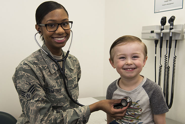 A senior airman of 366th Medical Support Squadron pediatric clinic checks vitals of the child of its service member at Mountain Home Air Force Base in Idaho. (Photo courtesy of U.S. Air Force)