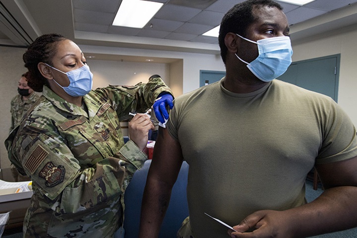 Image of Capt. Shamira Conerly, 149th Medical Group, gives Staff Sgt. Timmy Sanders, 149th Maintenance Squadron, his first dose of COVID-19 vaccine.
