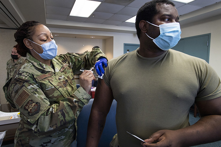 Capt. Shamira Conerly, 149th Medical Group, gives Staff Sgt. Timmy Sanders, 149th Maintenance Squadron, his first does of COVID-19 vaccine on Joint Base San Antonio-Lackland, Texas, March 18, 2021. Members of the 149th Fighter Wing who have opted to receive their vaccine have been scheduled over the past two weeks by the 149th Medical Group. (US Air National Guard Photo by Senior Airman Ryan Mancuso)