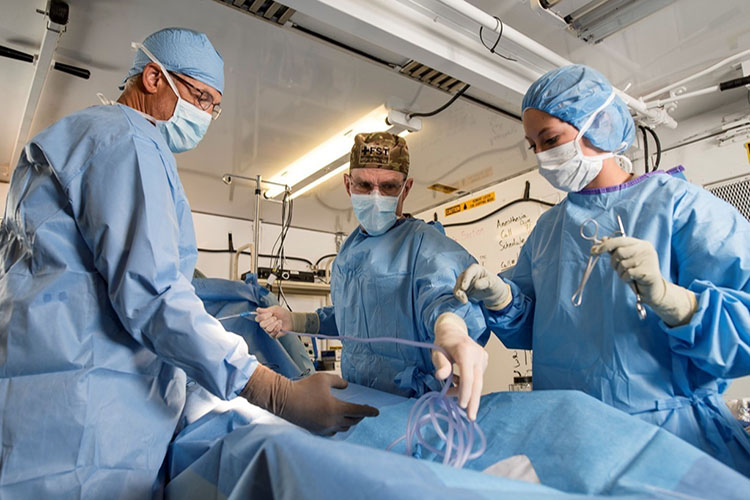 Image of Army Medicine surgeons in the operating room. Click to open a larger version of the image.