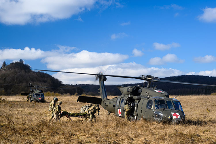 Image of U.S. Army Soldiers from the 115th Brigade Support Battalion, 1st Armored Brigade Combat Team, evacuate casualties onto waiting HH-60M MEDEVAC Blackhawk helicopters from Charlie Company, 6th Battalion, 101st Combat Aviation Brigade during Combined Resolve XV, Feb. 27, 2021, at Hohenfels Training Area. Combined Resolve XV is a Headquarters Department of the Army directed Multinational exercise designed to build 1st Armored Brigade Combat Team, 1st Cavalry Division’s readiness and enhance interoperability with allied forces and partner nations to fight and win against any adversary.(U.S. Army photo by Sgt. 1st Class Garrick W. Morgenweck). Click to open a larger version of the image.