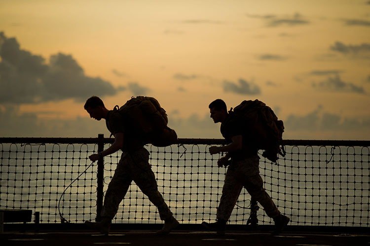 Image of Navy Lt. James E. Lamb, left, and Sgt. Ryan Eskandary exercise aboard USS Pearl Harbor. Click to open a larger version of the image.