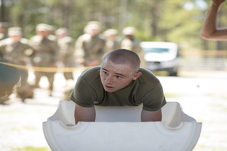 Image of Fort Jackson, SC. A trainee with 2nd Battalion, 60th Infantry Regiment puts his arms in an arm immersion cooling tank during training. The tanks allow Soldiers to rapidly cool by putting their forearms into a tank of ice water. (Photo by Saskia Gabriel). Click to open a larger version of the image.