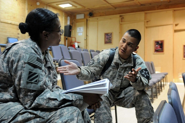 Image of  Capt. Elrico Hernandez, battalion physician assistant for 2nd Battalion, 3rd Infantry Regiment, 3rd Stryker Brigade Combat Team, 2nd Infantry Division, discusses a training scenario that is part of the first Primary Care Behavioral Health seminar. Click to open a larger version of the image.