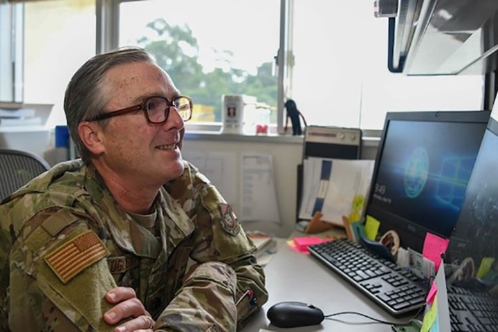 Image of U.S. Air Force Lt. Col. Eric Oglesbee, the PACAF Pediatric Psychological Developmental Team child psychologist with the 18th Healthcare Operations Squadron, demonstrates how a telehealth appointment would operate at Kadena Air Base, Japan, April 19, 2021. Providing pediatric mental health support to five overseas Air Force bases, P3DT uses both virtual and in-person. (U.S. Air Force photo by Airman 1st Class Anna Nolte).