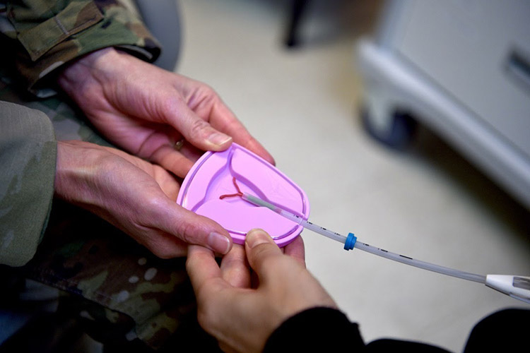 Lt. Col. Paula Neemann, 15th Healthcare Operations Squadron clinical medicine flight commander, demonstrates several birth options, such as an intrauterine device, at the 15th MDG's contraceptive clinic at Joint Base Pearl Harbor-Hickam, Hawaii, May 6, 2021. The contraceptive clinic opened June 7 to service beneficiaries and provide same-day procedures without a referral. (U.S. Air Force photo by 2nd Lt. Benjamin Aronson)