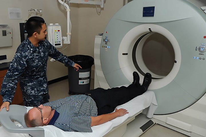 Image of A patient at Naval Hospital Pensacola prepares to have a low-dose computed tomography test done to screen for lung cancer. Lung cancer is the leading cause of cancer-related deaths among men and women. Early detection can lower the risk of dying from this disease. (U.S. Navy photo by Jason Bortz).