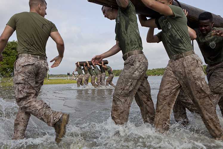 Image of Marines carrying a wooden log for physical fitness. Click to open a larger version of the image. Click to open a larger version of the image.