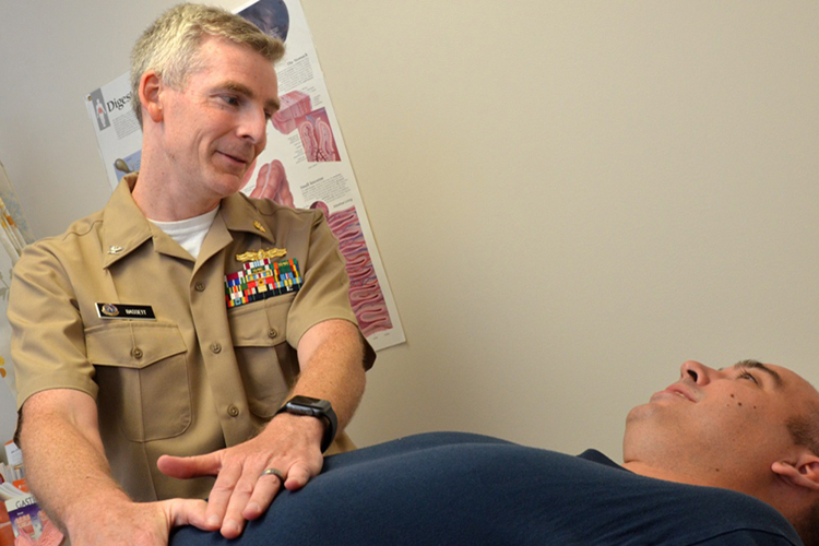 A physician examines and educates a patient. (U.S. Navy photo by Jacob Sippel, Naval Hospital Jacksonville/Released)
