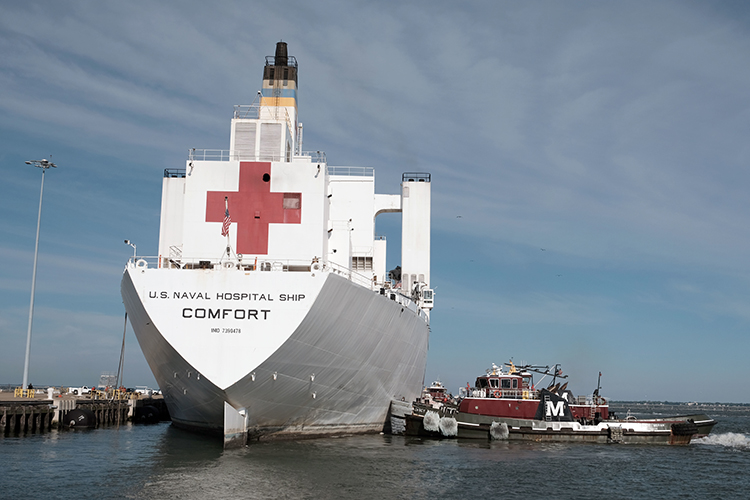 Image of Hospital ship USNS Comfort returns to its homeport after treating patients in New York and New Jersey in support of the COVID-19 pandemic. Click to open a larger version of the image.